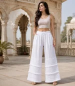 White Lucknowi Chikankari palazzo with layered embroidered panels, frill accents, and hand embroidery, available from Fiza Chikan Dubai, UAE.