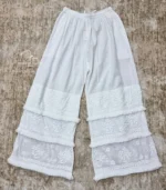 White Lucknowi Chikankari palazzo with layered embroidered panels, frill accents, and hand embroidery, available from Fiza Chikan Dubai, UAE.