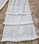 White Lucknowi Chikankari palazzo with layered embroidered panels, frill accents, and hand embroidery, available from Fiza Chikan Dubai, UAE.