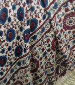 Shop a beige Ajrakh Modal Satin dupatta with deep blue and red motifs, finished with a lustrous Lagdi Patta border and tassels. Available in Dubai, UAE.